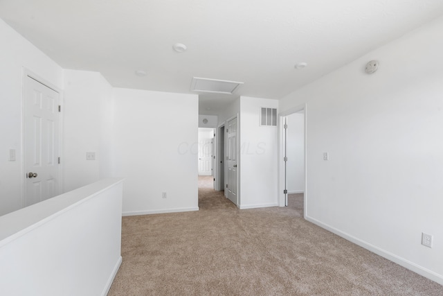 spare room featuring light colored carpet