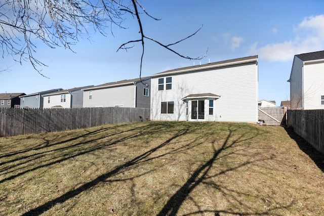 rear view of house with a yard