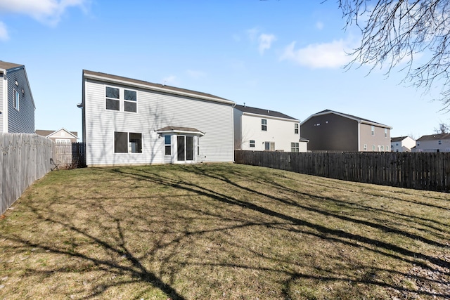 back of house featuring a yard