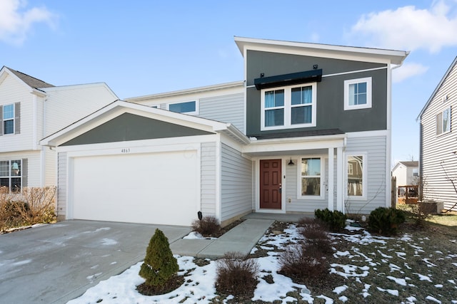 view of front of house featuring a garage and central air condition unit