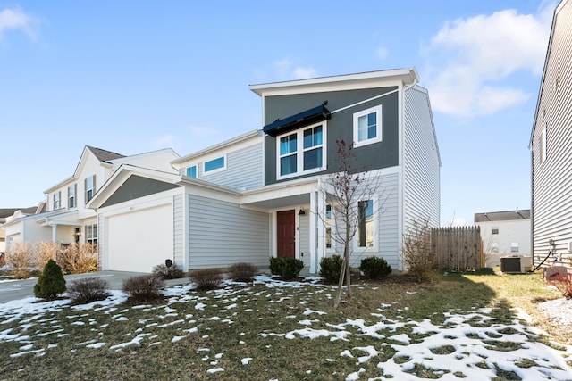 view of front of home with a garage and cooling unit