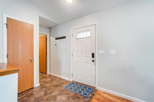 entryway with a textured ceiling