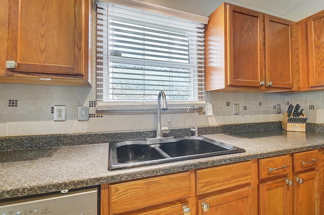 kitchen with sink, decorative backsplash, and dishwasher