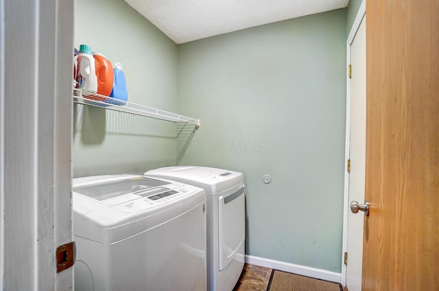 laundry room featuring tile patterned flooring and washer and clothes dryer