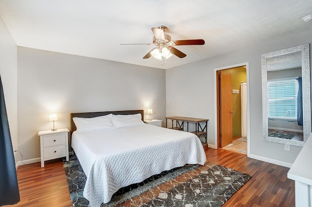 bedroom with dark hardwood / wood-style floors and ceiling fan