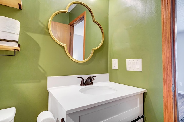 bathroom featuring vanity and toilet