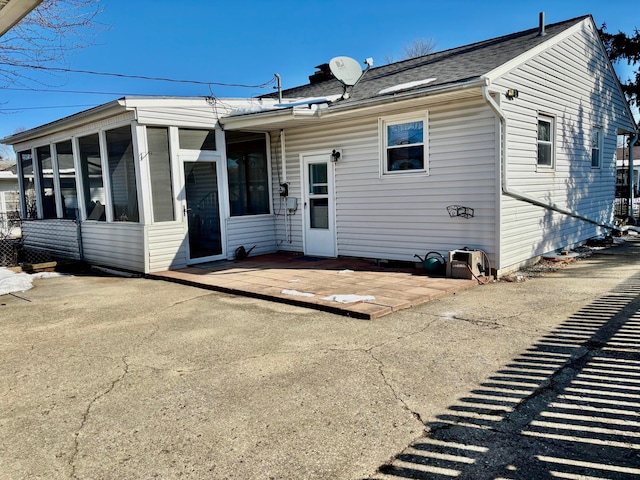 view of front of home with a patio area and a sunroom