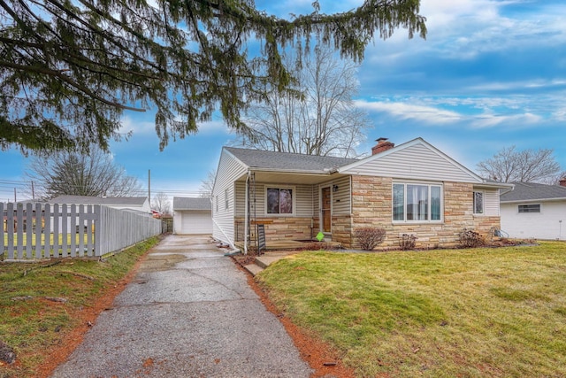 view of front of home with an outbuilding, a garage, and a front yard