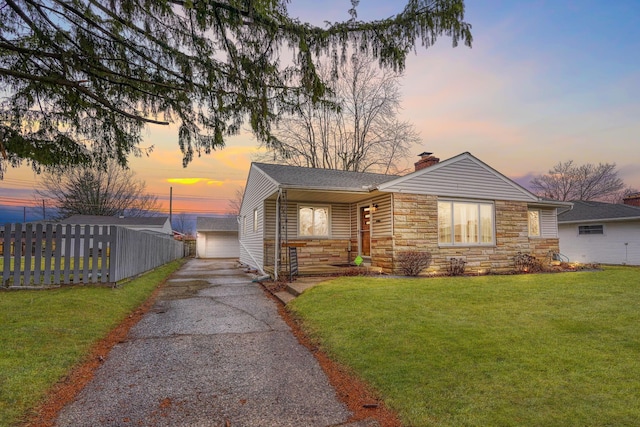 view of front of house with an outbuilding, a yard, and a garage