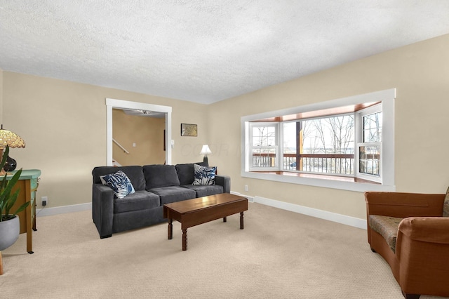 living room featuring light carpet and a textured ceiling