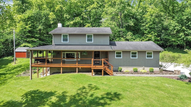 view of front of home with a wooden deck and a front lawn