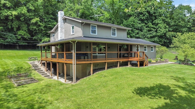 rear view of house with a sunroom and a lawn