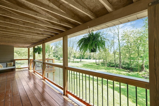 wooden deck featuring a yard