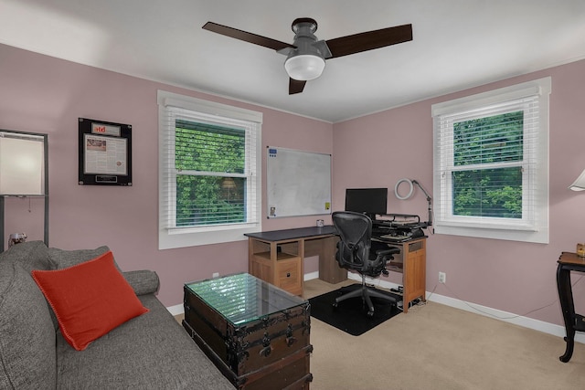 carpeted office featuring ceiling fan