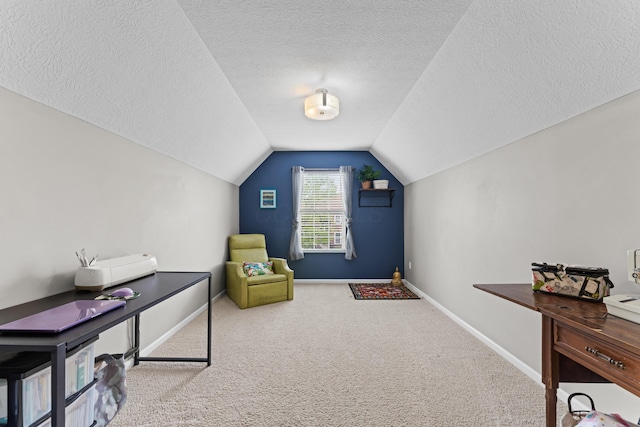 sitting room with carpet floors, vaulted ceiling, a textured ceiling, and baseboards