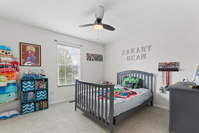 carpeted bedroom with baseboards and ceiling fan