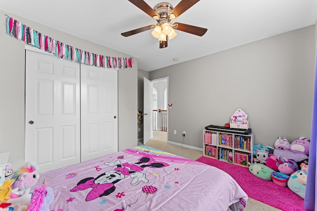 carpeted bedroom with a closet, a ceiling fan, and baseboards