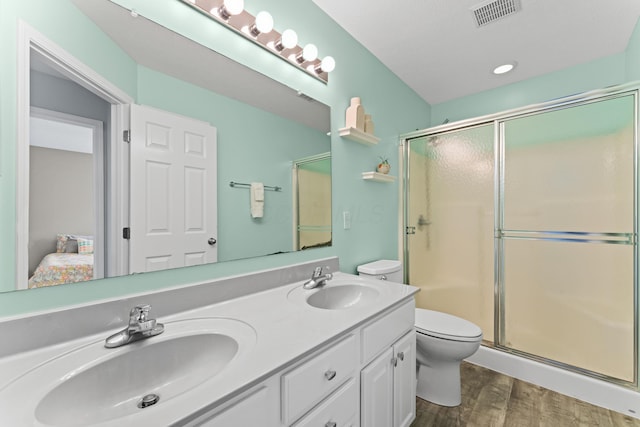 full bathroom with wood finished floors, visible vents, a sink, and toilet