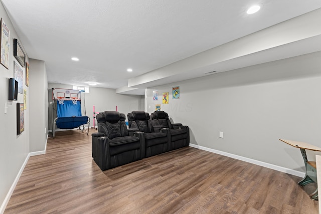 living area featuring baseboards, wood finished floors, and recessed lighting