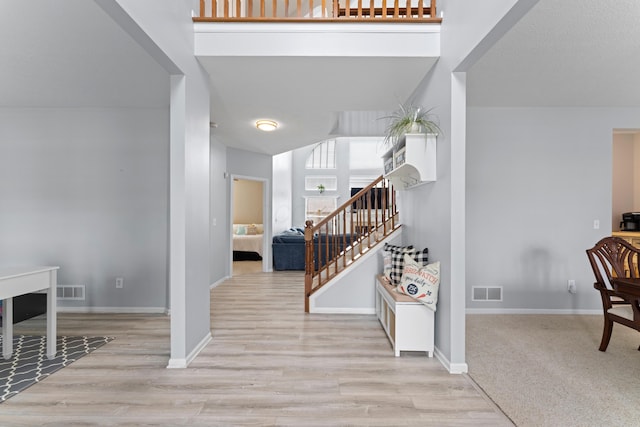 entryway featuring baseboards, wood finished floors, and visible vents