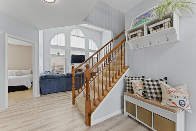 stairway with baseboards and wood finished floors