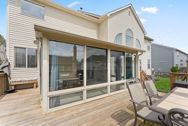 wooden deck featuring a sunroom