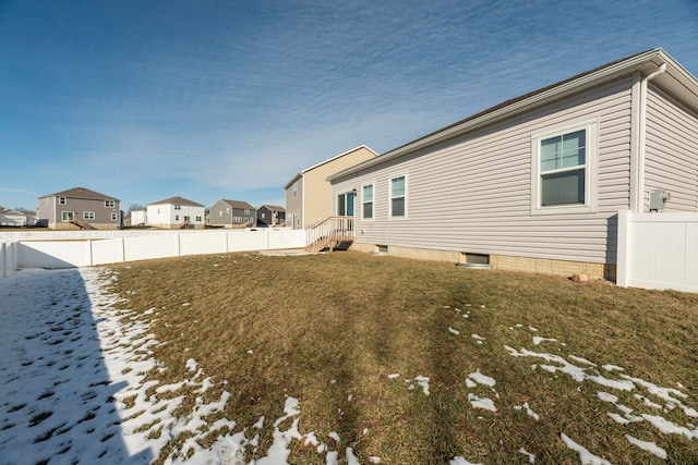 snow covered property with a yard