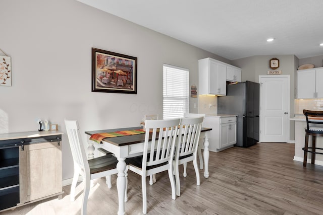 dining space with light hardwood / wood-style flooring