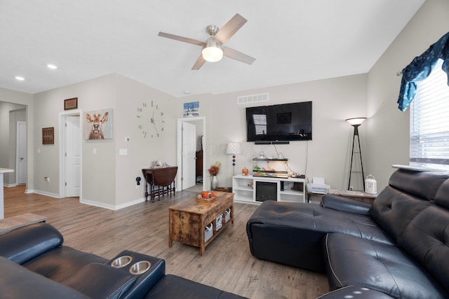 living room featuring hardwood / wood-style flooring and ceiling fan