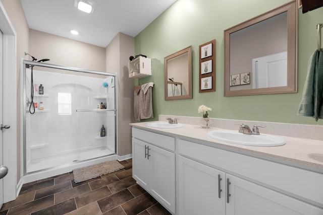 bathroom featuring walk in shower and vanity