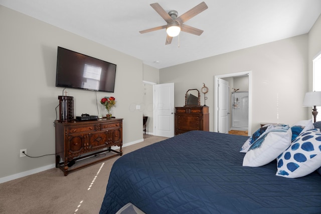 carpeted bedroom with ceiling fan and ensuite bath