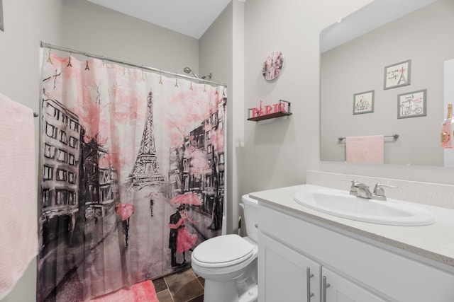 bathroom with vanity, curtained shower, and toilet