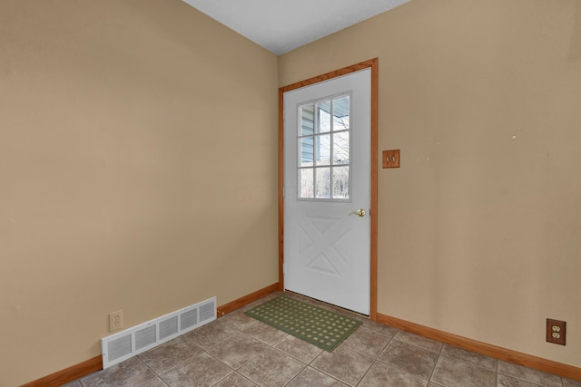 doorway with light tile patterned flooring