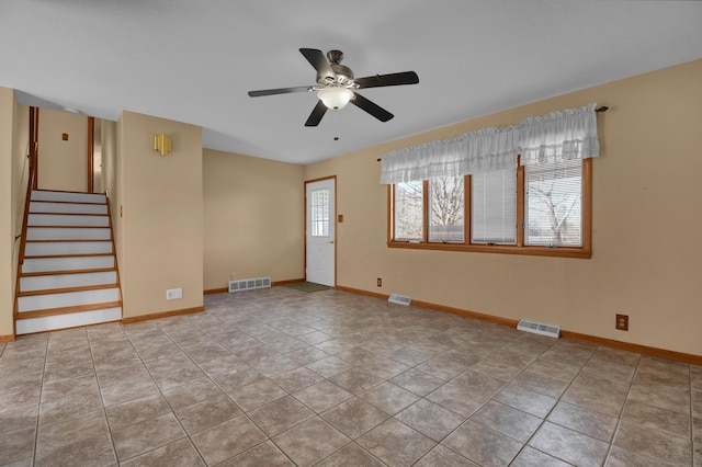 tiled empty room with ceiling fan