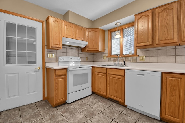 kitchen with white appliances, decorative light fixtures, sink, and decorative backsplash