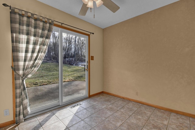 tiled spare room featuring ceiling fan