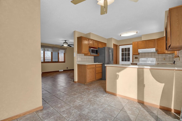 kitchen with light tile patterned flooring, sink, backsplash, kitchen peninsula, and stainless steel appliances