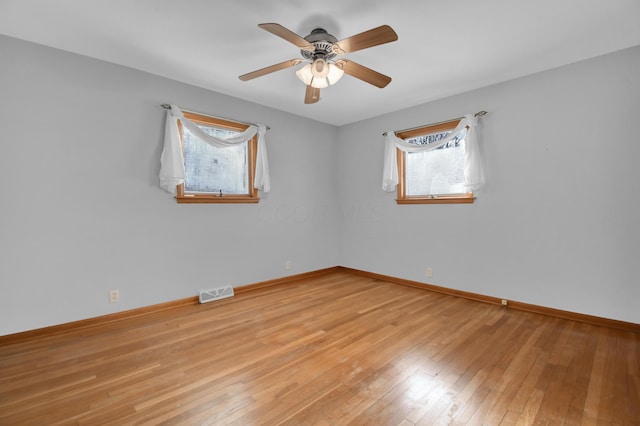 empty room featuring ceiling fan and light hardwood / wood-style floors