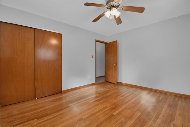 unfurnished bedroom with light hardwood / wood-style flooring, a closet, and ceiling fan