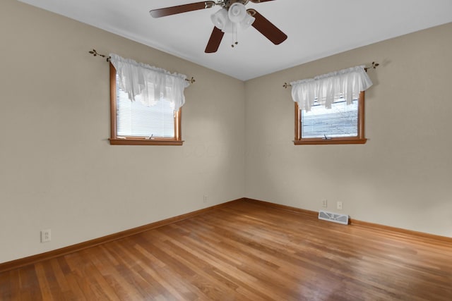 unfurnished room with hardwood / wood-style floors