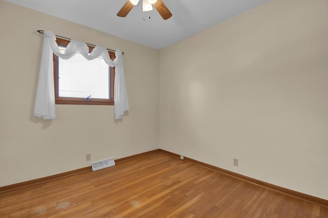 unfurnished room with ceiling fan and light wood-type flooring