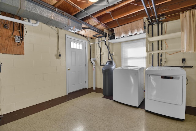 clothes washing area with separate washer and dryer