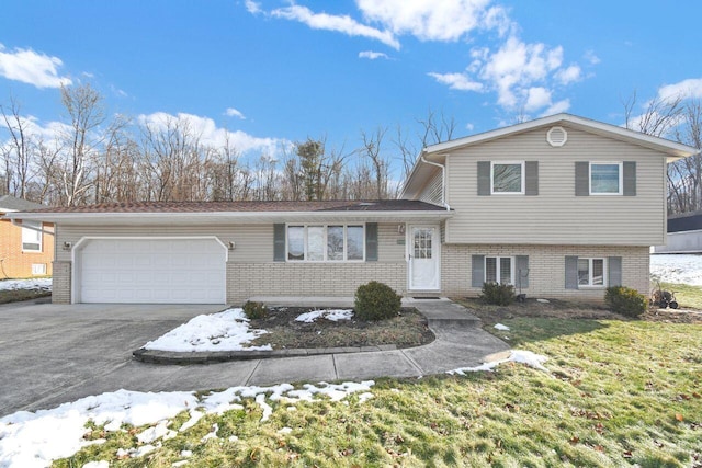 split level home with a garage and a lawn