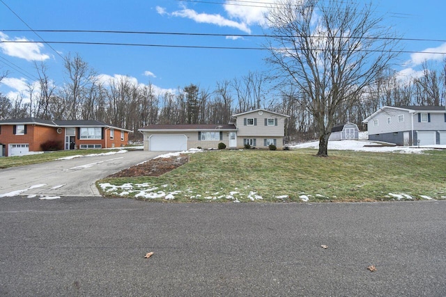 view of front facade with a garage and a front lawn