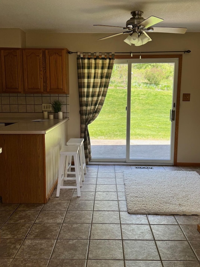 interior space featuring a ceiling fan and tile patterned floors