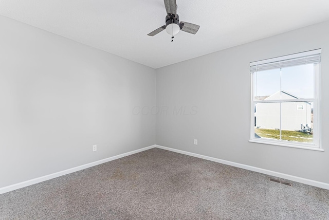 spare room featuring ceiling fan and carpet