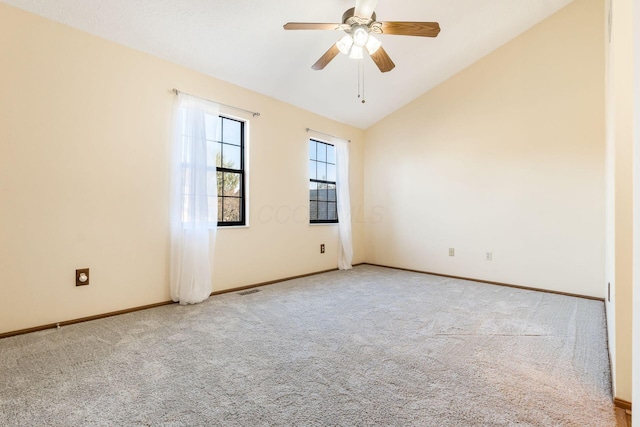 carpeted empty room featuring vaulted ceiling and ceiling fan