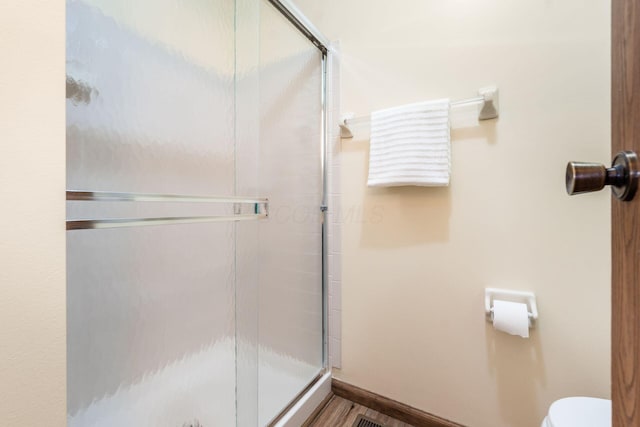 bathroom featuring toilet and walk in shower