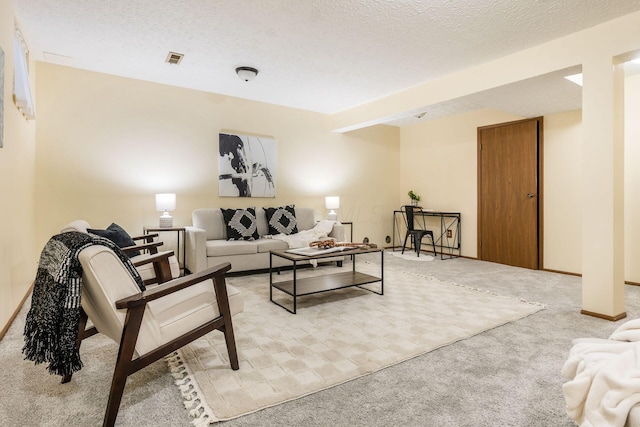 carpeted living room with a textured ceiling