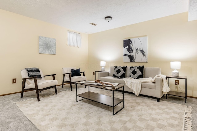 carpeted living room with a textured ceiling